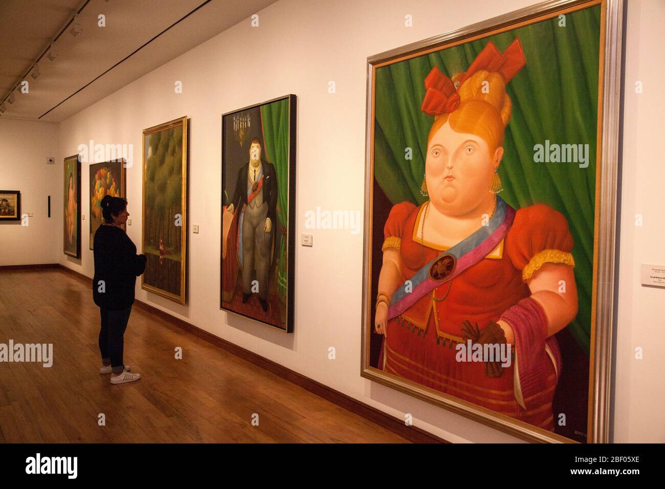Onlookers admiring the La primera dama, First Lady painting by Botero in a gallery at the Botero Museum also known as Museo Botero, Bogotá, Colombia Stock Photo
