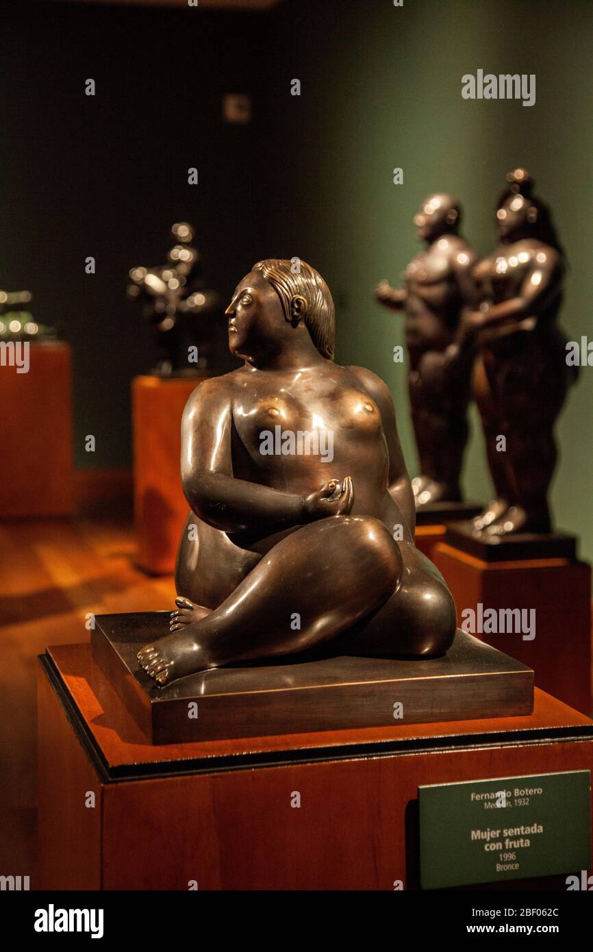 Mujer sentado con fruta, woman sitting with fruit, bronze scupture by Boteroat at the Botero Museum also known as Museo Botero, Bogotá, Colombia. Stock Photo