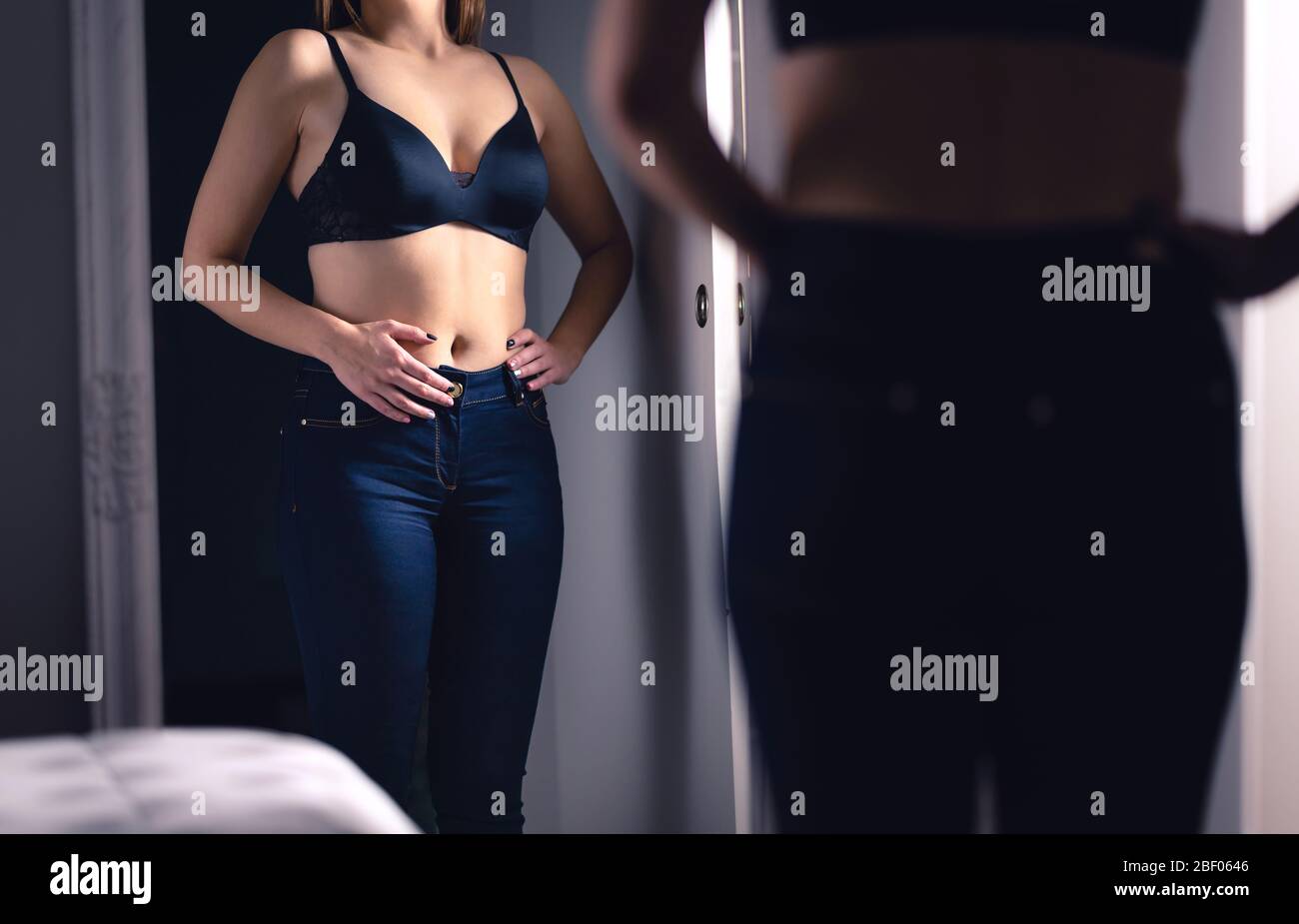 Menstrual pain, diet and weight loss, digestion problem and constipation or early pregnancy concept. Woman touching and holding hand on stomach. Stock Photo