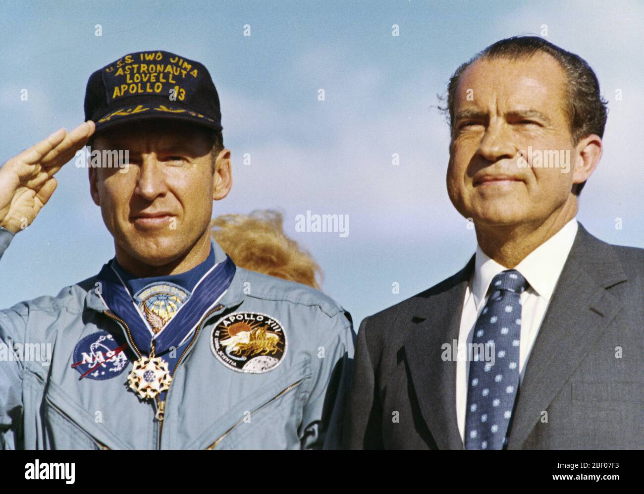 HONOLULU, HAWAII - The Apollo 13 Flight Commander James A. Lovell, Jr. stands alongside President Richard M. Nixon during the playing of the National Anthem after presentation ceremonies awarding the Apollo 13 Flight Crew the Presidential Medal of Freedom. Stock Photo