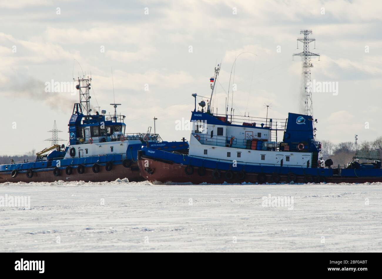 Tugboats work on the river. Spring navigation Stock Photo - Alamy