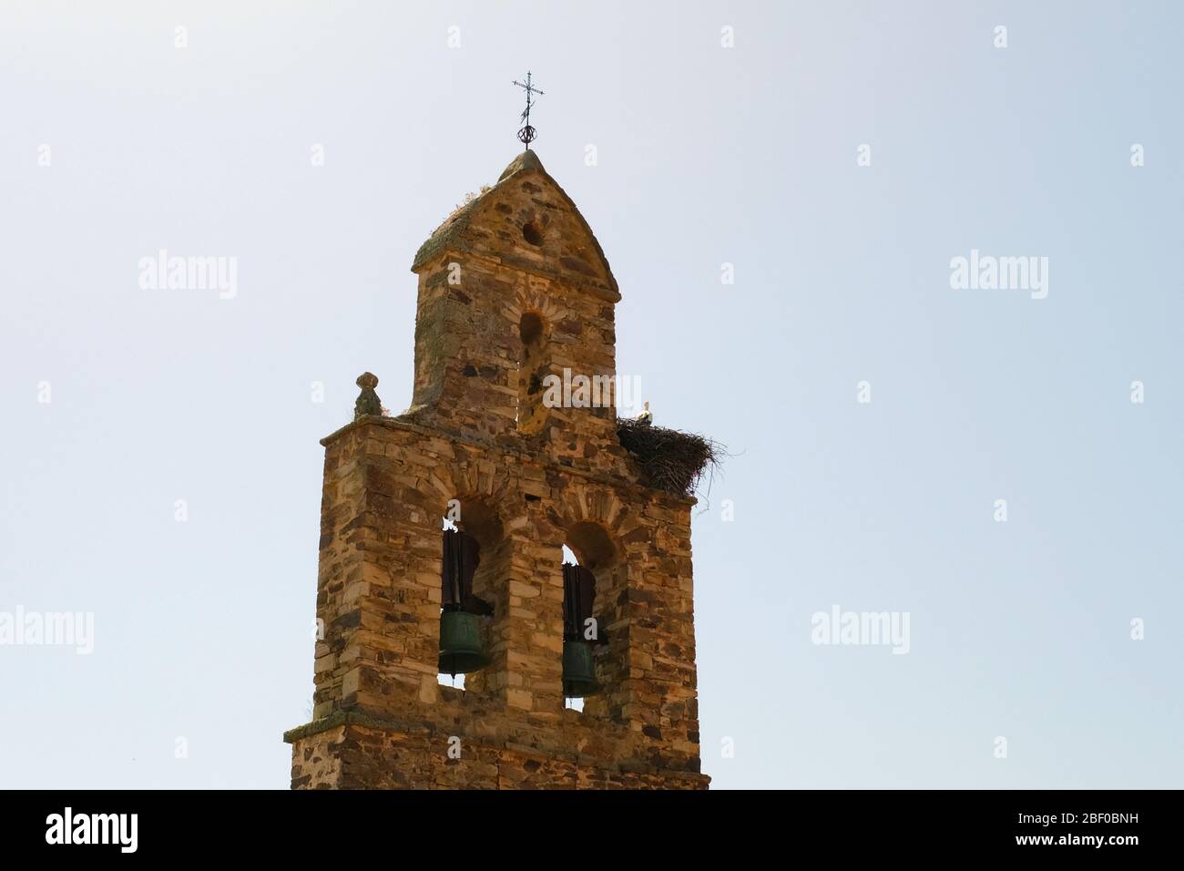 Tall bell tower with a cross, camion de santiago, Spain. Stock Photo