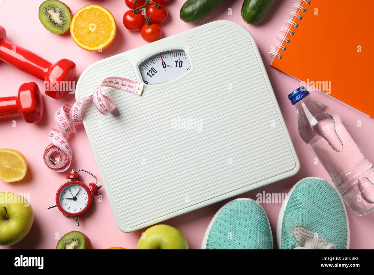 https://c8.alamy.com/comp/2BF0BRH/weight-loss-or-healthy-lifestyle-accessories-on-pink-background-2BF0BRH.jpg