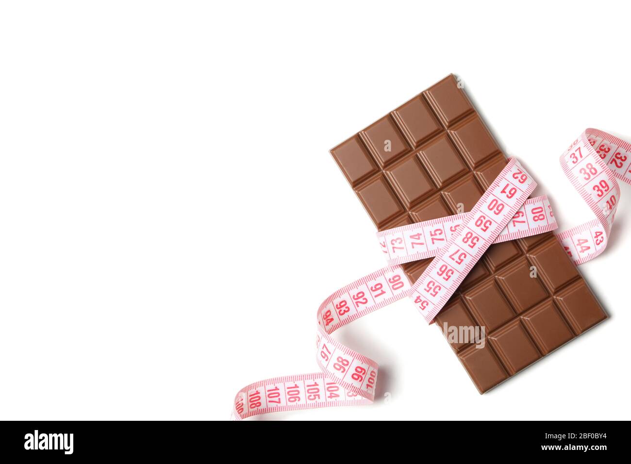 Measuring tape and chocolate bar on white background Stock Photo - Alamy