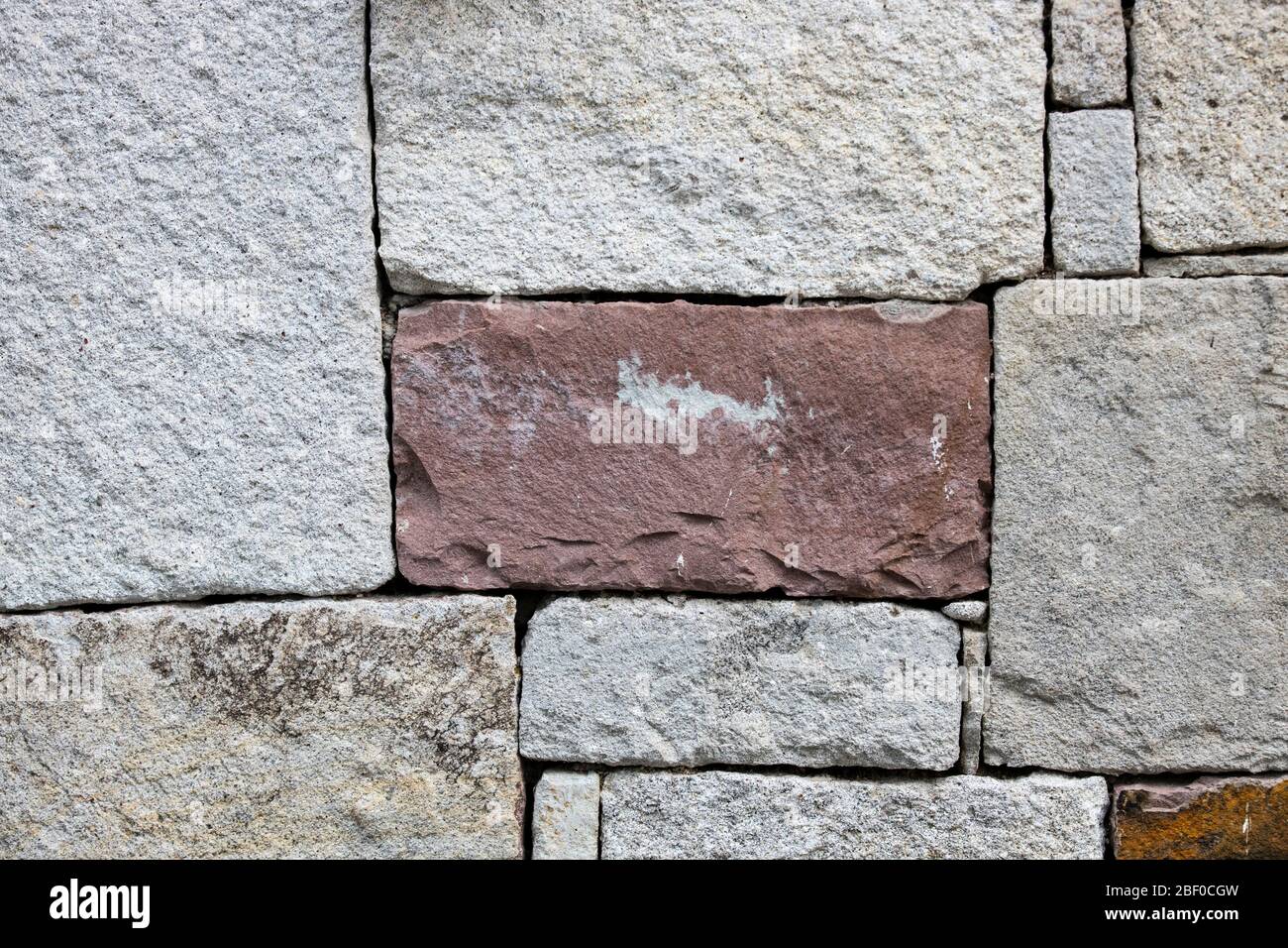 Wall made of rock pieces cut in rectangular shape. Stock Photo