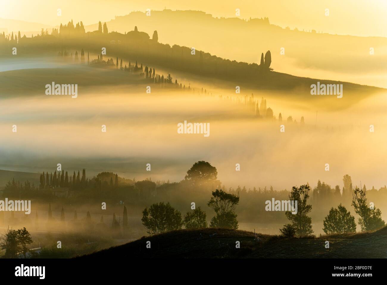 a misty sunrise in the crete senesi landscape close to Asciano, Tuscany Stock Photo