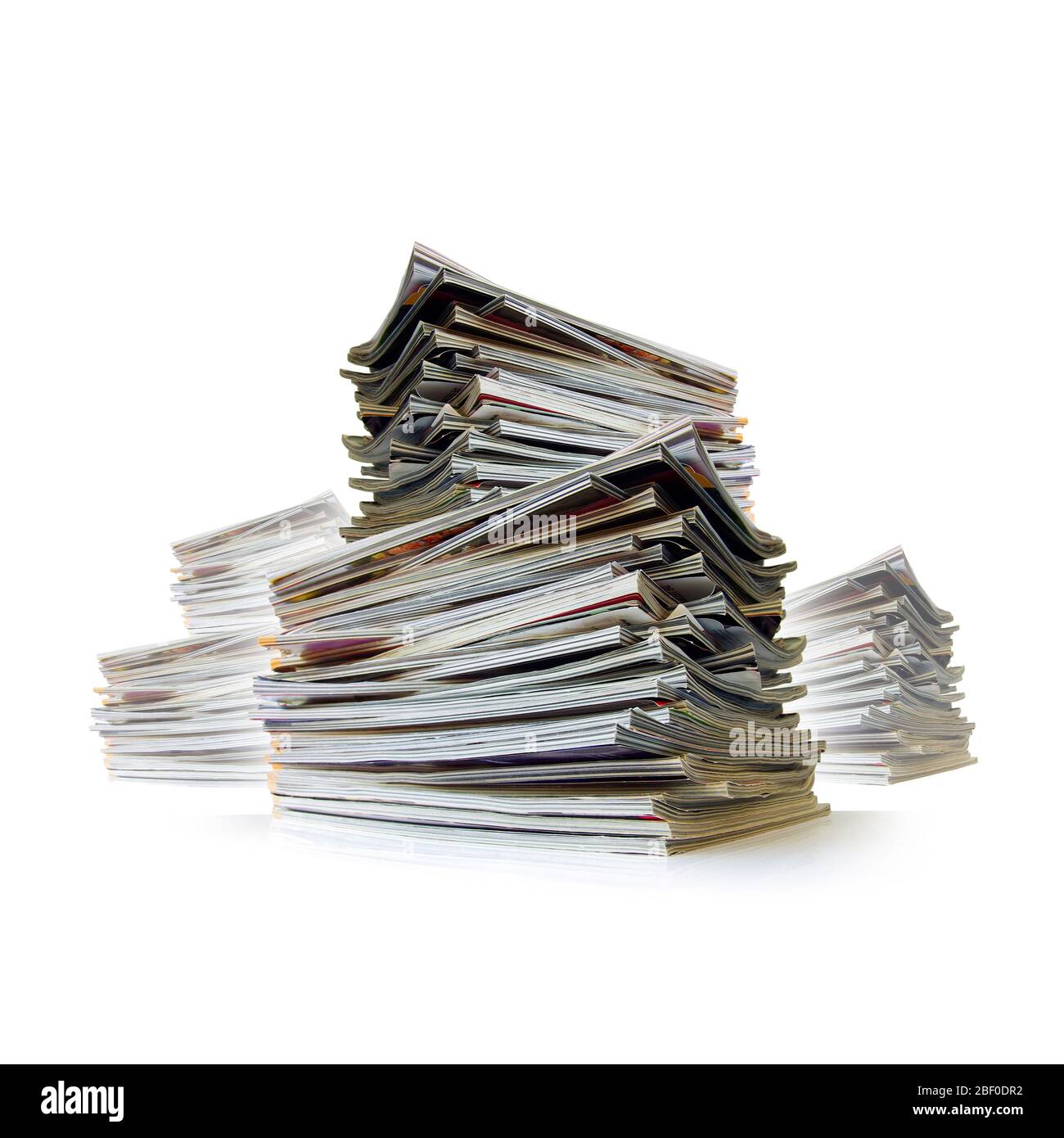 Closeup of messy piles of old magazines with bending pages Stock Photo