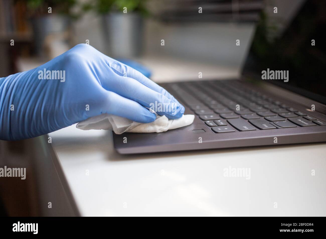 office sanitizing wipe wiping laptop keyboard with disinfecting wipes