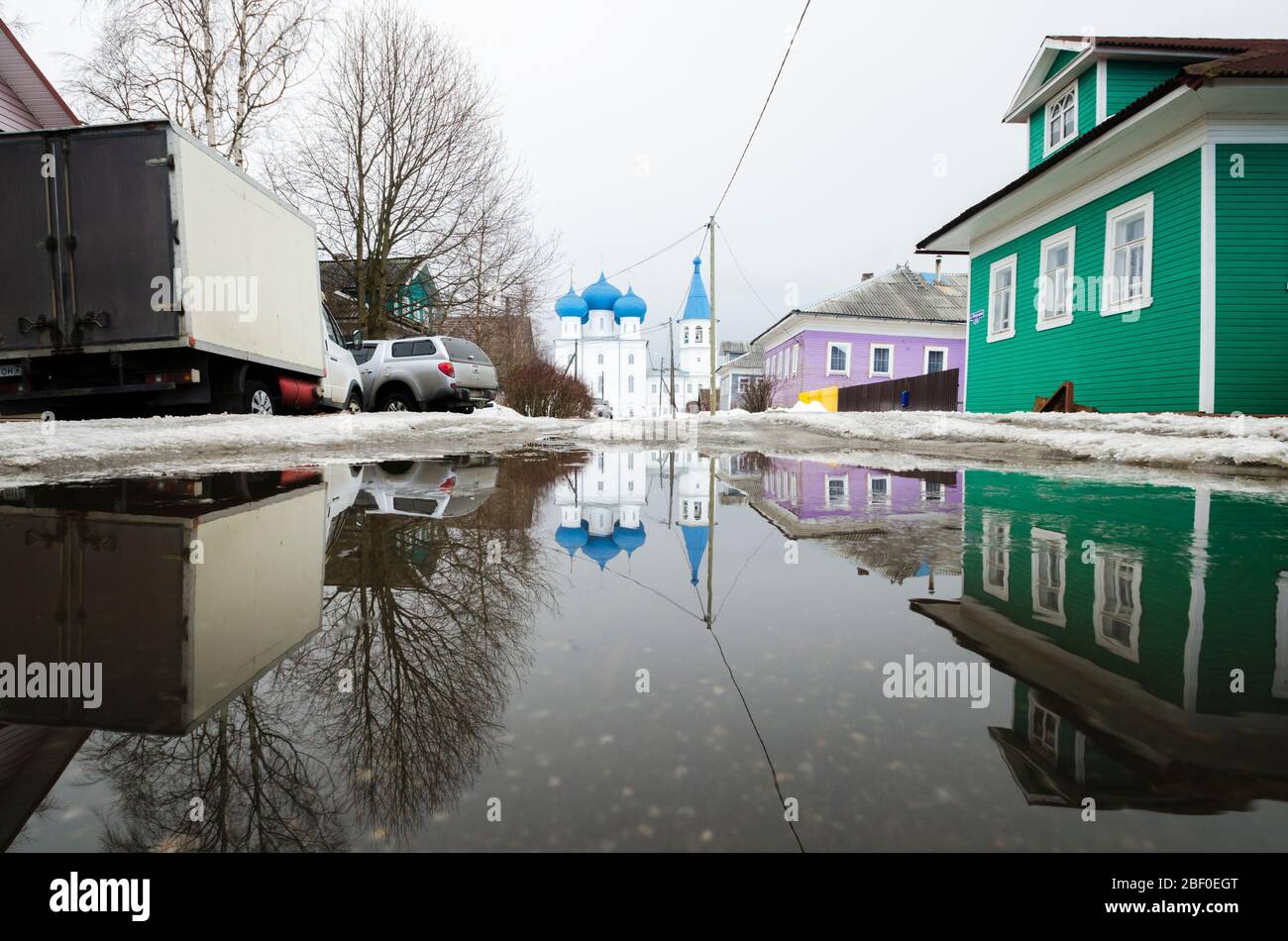 Spring in the Russian village. Spring flood. Huge puddles Stock Photo