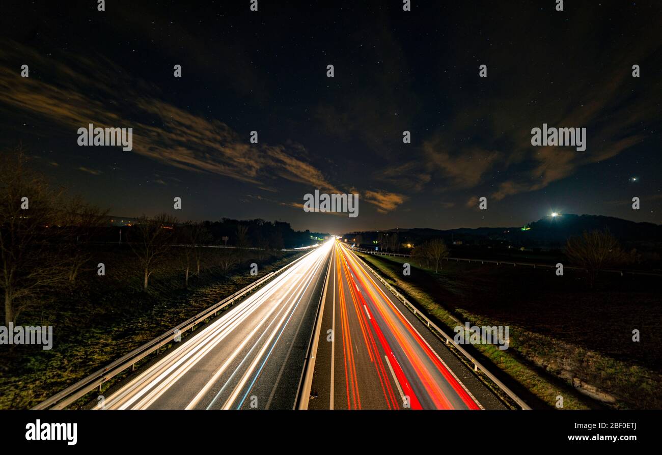 Perspective of a highway as cars passed by, returning from skiing over the weekend Stock Photo
