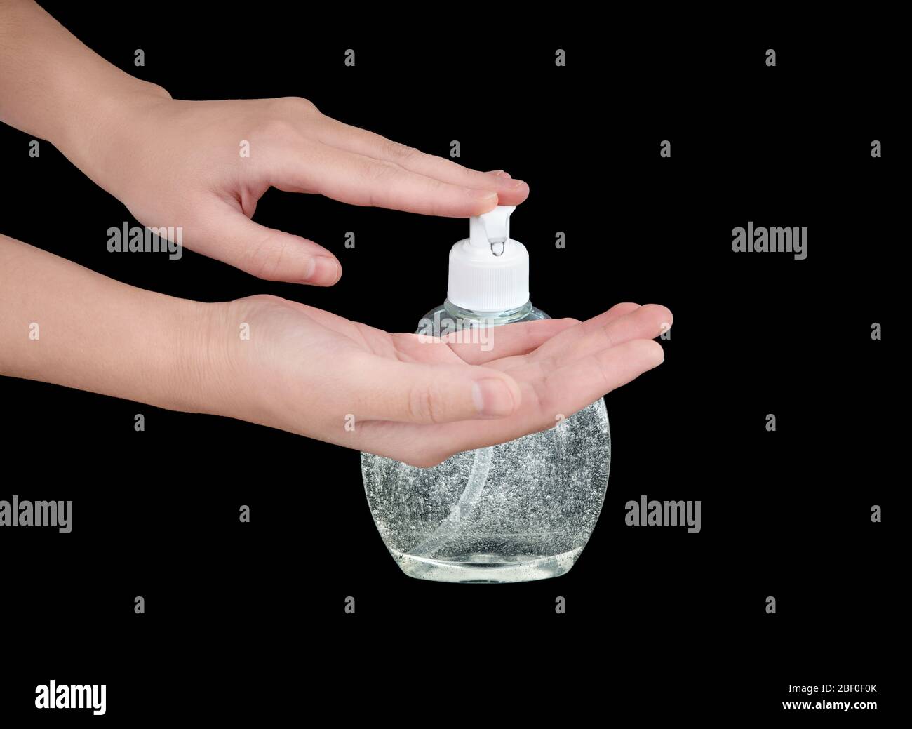 Female hands press a drop of alcohol-based sanitizer out of a liquid soap dispenser to apply. Mean of antibacterial disinfection and hygiene. Stock Photo