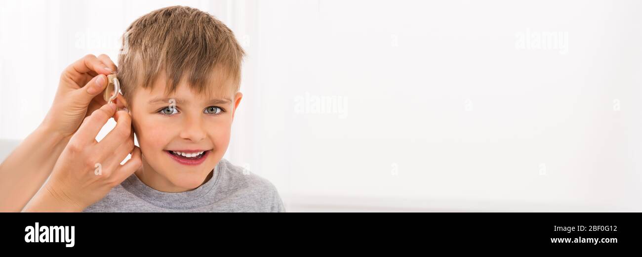 Hearing Aid For Deaf Boy With Hear Impairment Stock Photo