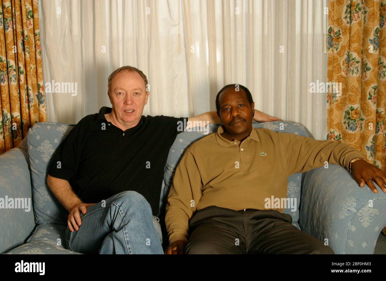 Director Terry George with Paul Rusesabagina in Philadelphia, PA.  November, 2004.  George's new film HOTEL RWANDA tells the story of Rusesabagina - a hotel manager who housed over a thousand Tutsis refugees during their struggle against the Hutu militia in Rwanda.  Credit: Scott Weiner/MediaPunch Stock Photo