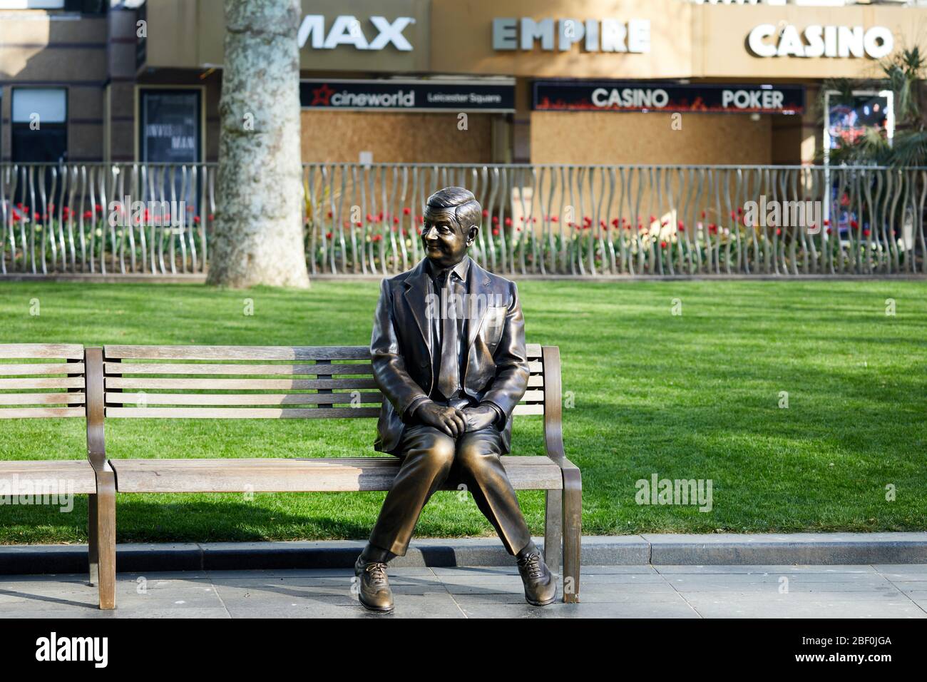 London, U.K. - 16 Apr 2020: A statue of Mr Bean in front of a boarded-up Empire Leicester Square, closed during the Covid-19 coronavirus pandemic lockdown. Stock Photo
