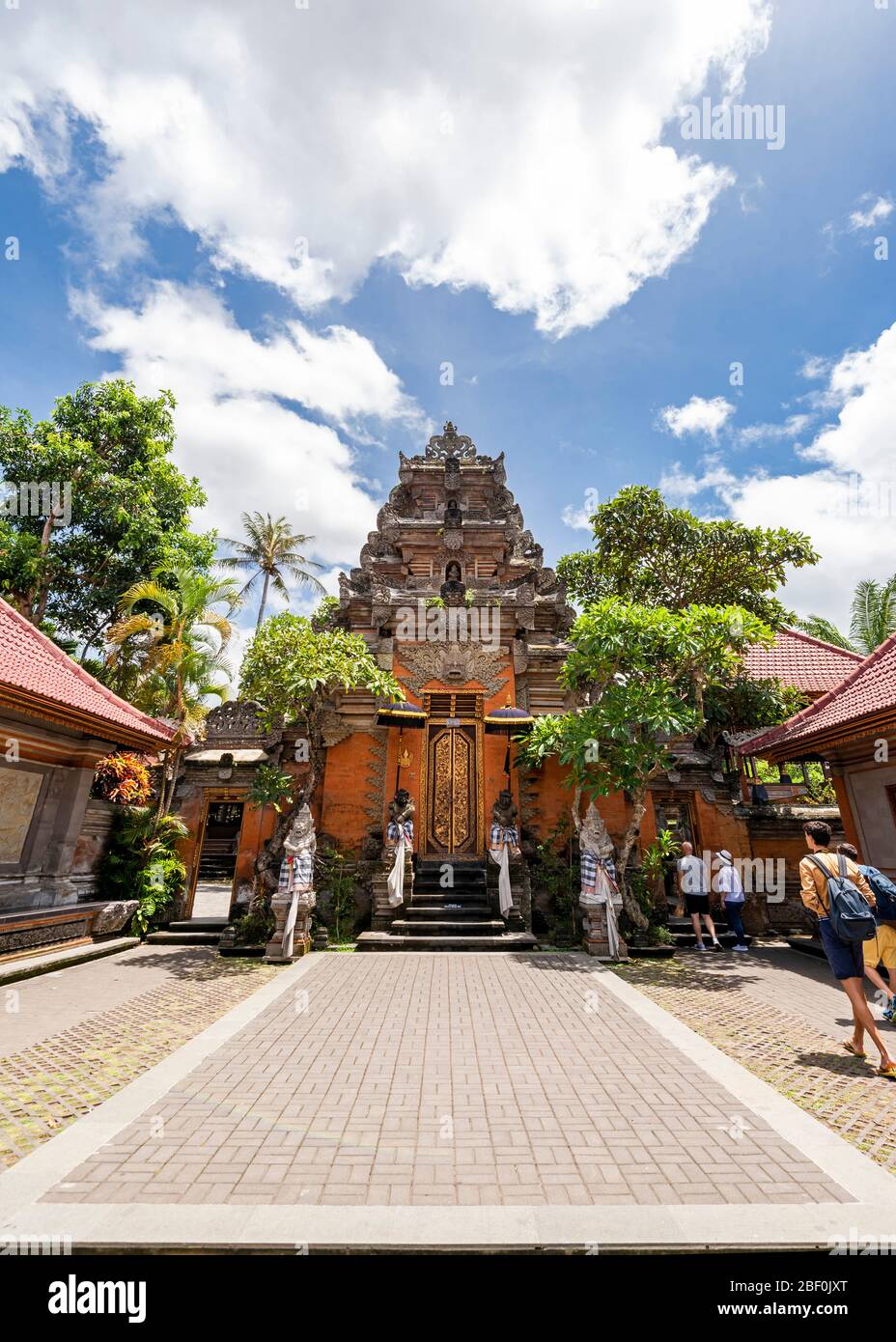 Vertical view of tourists at the main gates of Ubud palace in Bali, Indonesia. Stock Photo