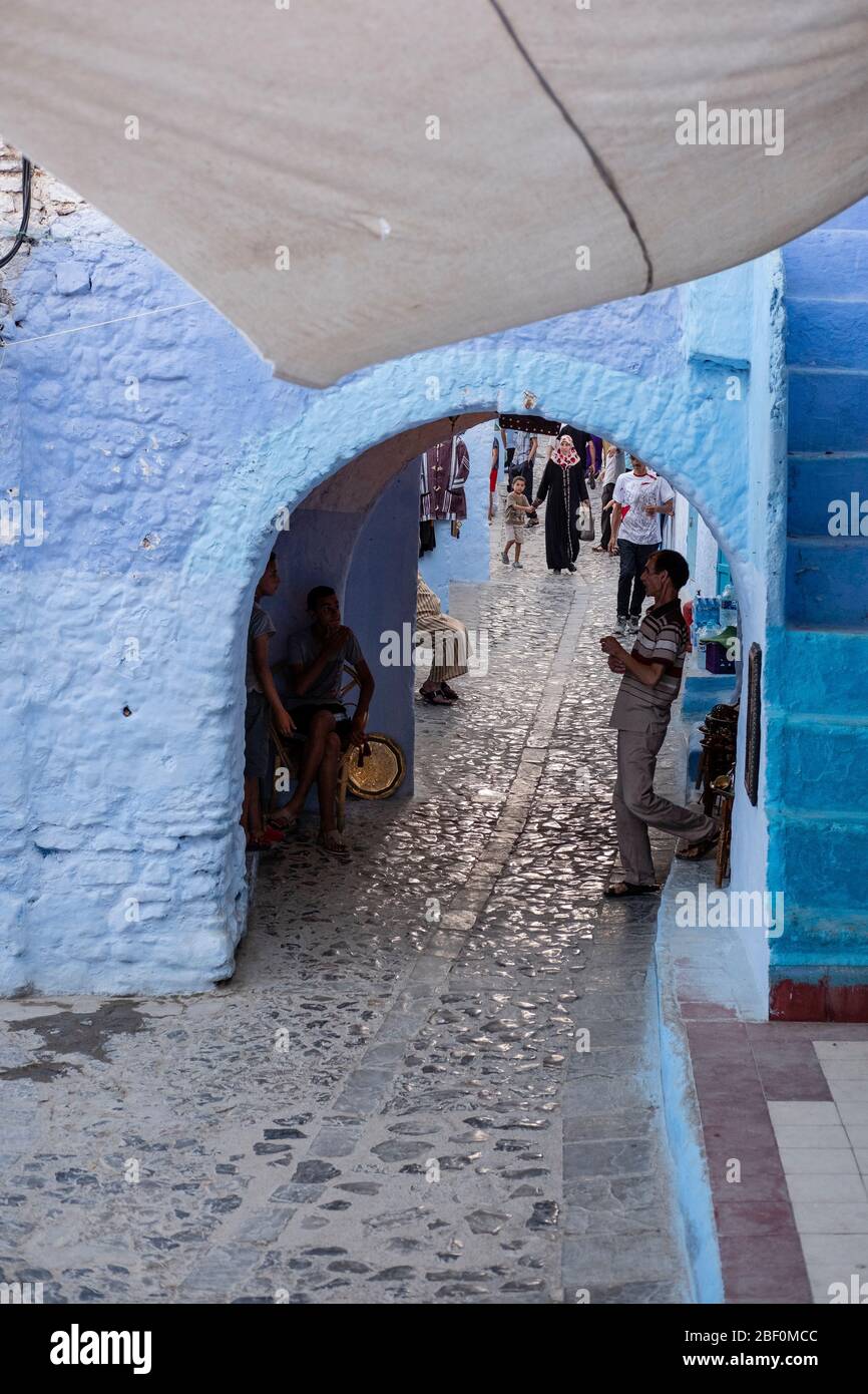 Chefchaouen, northern Morocco, June 10, 2016. Intense commercial activity in one of the main streets of the blue city, full of bazaars. Stock Photo