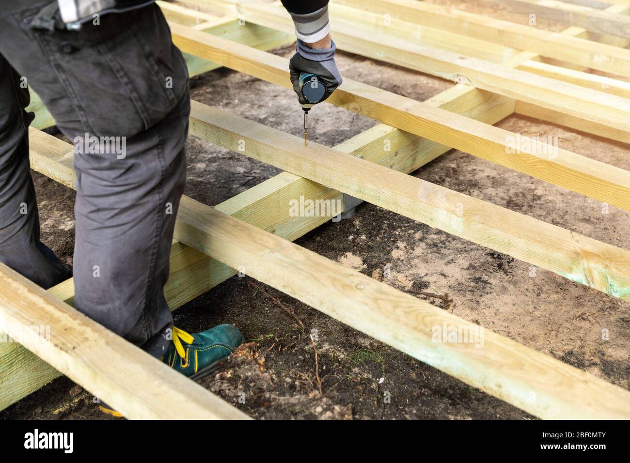 construction worker building wooden frame for terrace deck Stock Photo
