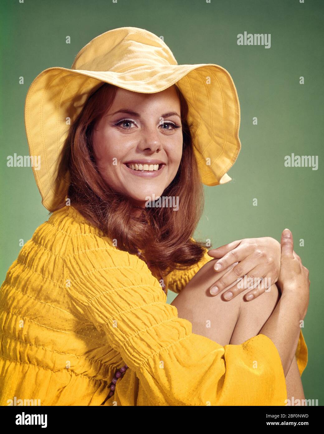 WEARING YELLOW FLOPPY BRIM HAT 