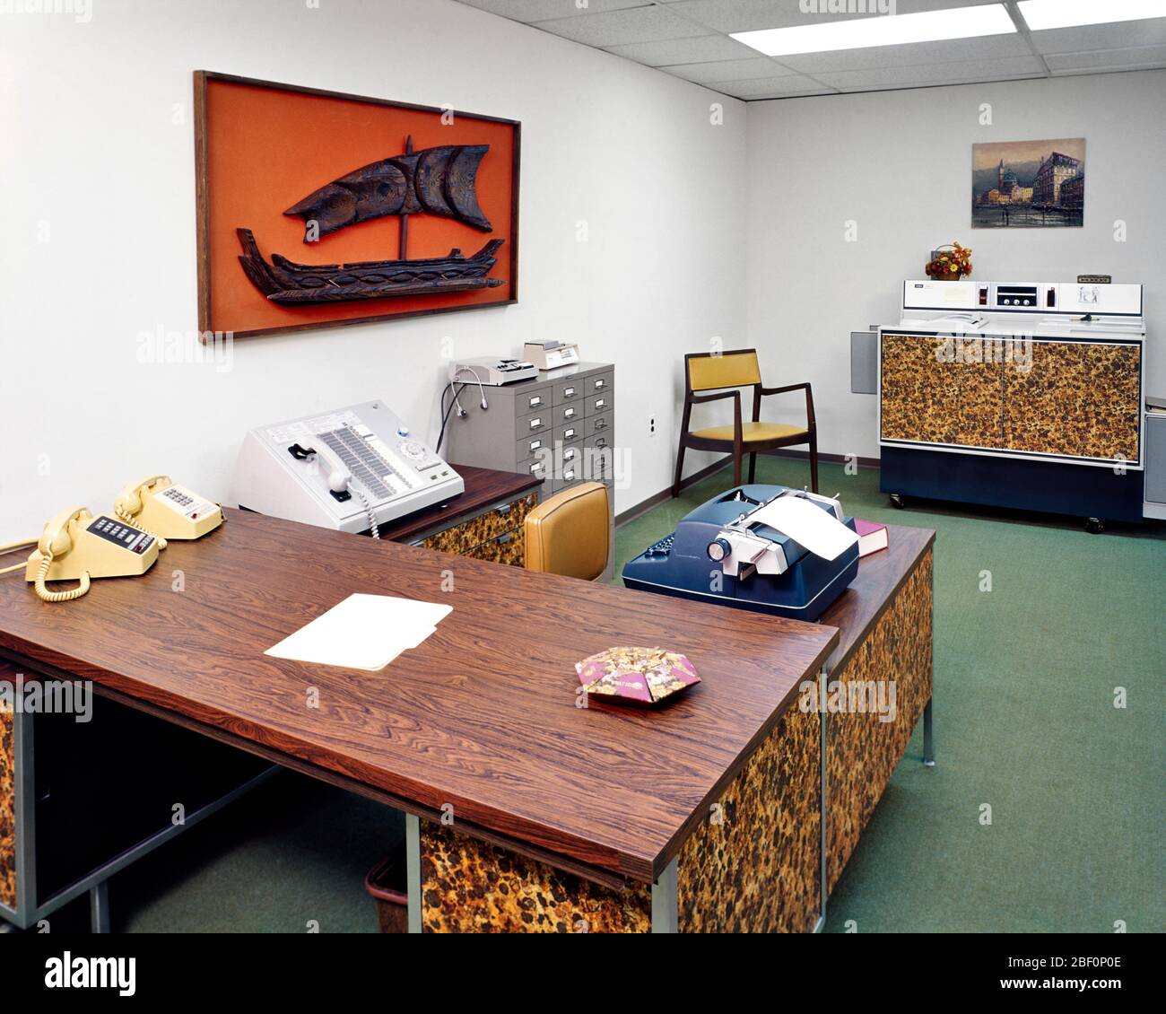 1960s 1970s OFFICE INTERIOR RECEPTION FRONT DESK WITH TELEPHONE SWITCH BOARD ELECTRIC TYPEWRITER AND COPY MACHINE ON BACK WALL - ki2404 HAR001 HARS OLD FASHIONED Stock Photo