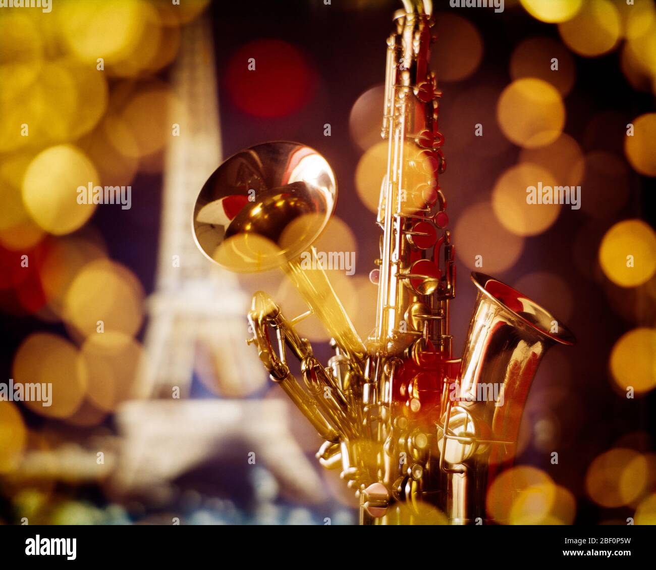 1980s SYMBOLIC JAZZ STILL LIFE BRASS MUSICAL INSTRUMENTS SAXOPHONE TRUMPET EIFFEL TOWER AND GOLDEN LIGHTS OF PARIS IN BACKGROUND - km7050 PHT001 HARS JAZZ TRIP AND GETAWAY COMPOSITE EXCITEMENT IN OF HOLIDAYS SAXOPHONE MUSICAL INSTRUMENT CONCEPT CONCEPTUAL STILL LIFE STYLISH SYMBOLIC CONCEPTS CREATIVITY NIGHTLIFE VACATIONS WILDLIFE EIFFEL TOWER OLD FASHIONED REPRESENTATION Stock Photo