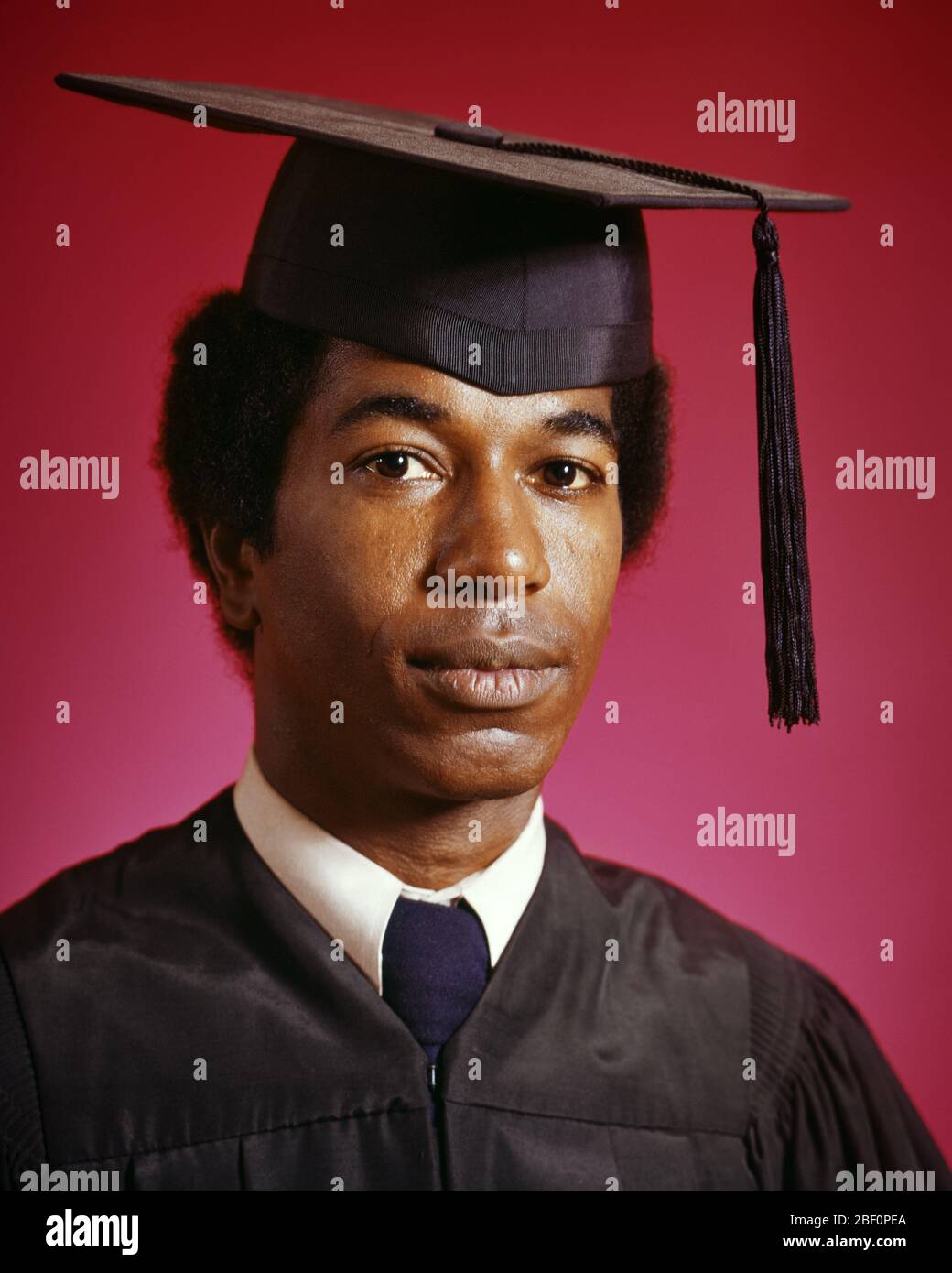 1970s Portrait African American Man Wearing Graduation Cap And Robes Looking At Camera Ks13062 Har001 Hars African American And Knowledge Leadership Black Ethnicity Pride Higher Education Colleges Mortarboard Young Adult Man Cap And