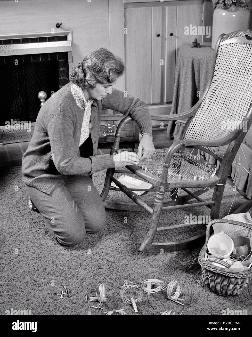 1960s 1970s MIDDLE AGE WOMAN CRAFTSPERSON CANING ROCKING CHAIR SEAT HOBBY REPAIR ART HANDY CRAFTS HOME IMPROVEMENT HOUSEHOLD DIY - s17320 HAR001 HARS SEAT REPAIR ROCKING INFORMATION RELAXING JOY LIFESTYLE SATISFACTION ELDER FEMALES GROWNUP HOME LIFE COPY SPACE FULL-LENGTH HALF-LENGTH LADIES CRAFTS PERSONS INSPIRATION GROWN-UP CRAFT CONFIDENCE MIDDLE-AGED B&W GOALS SKILL ACTIVITY AMUSEMENT HAPPINESS OLD AGE MIDDLE-AGED WOMAN OLDSTERS OLDSTER ADVENTURE HOBBY LEISURE IMPROVEMENT INTEREST CHOICE HOBBIES KNOWLEDGE PROGRESS RECREATION PASTIME PRIDE PLEASURE AUTHORITY OCCUPATIONS ELDERS CANING Stock Photo