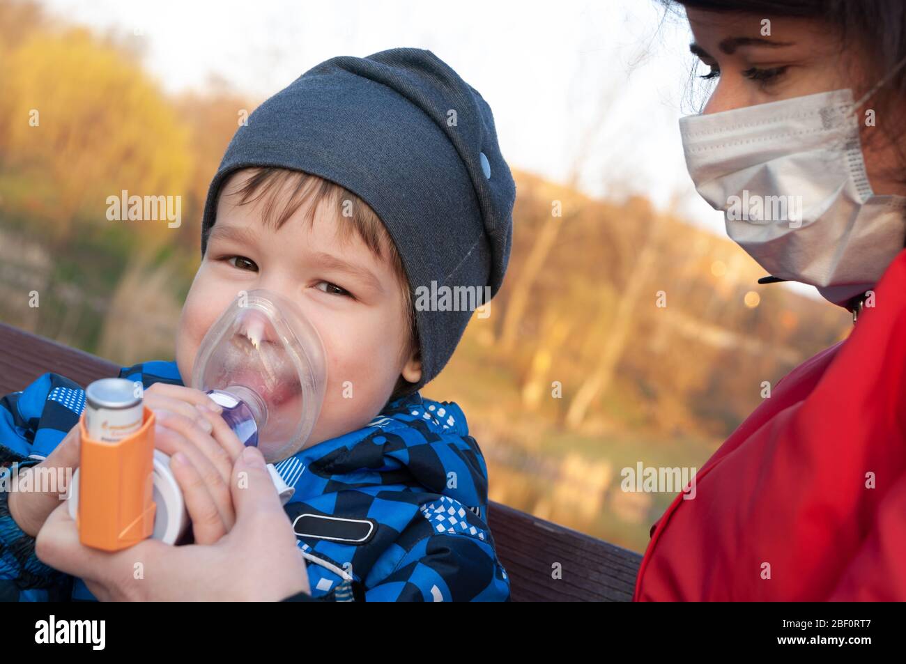 A small boy who suffering from illness bronchial asthma getting treatment with aerosol inhaler. Prevention of complications Stock Photo