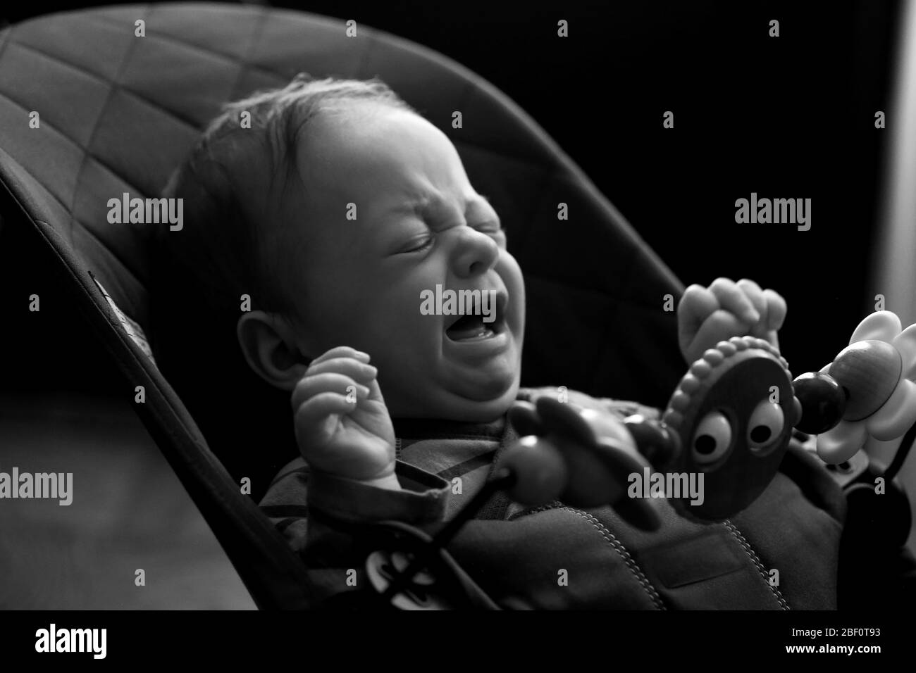Baby crying in infant chair, classic black and white, NYC April 2020 Stock Photo