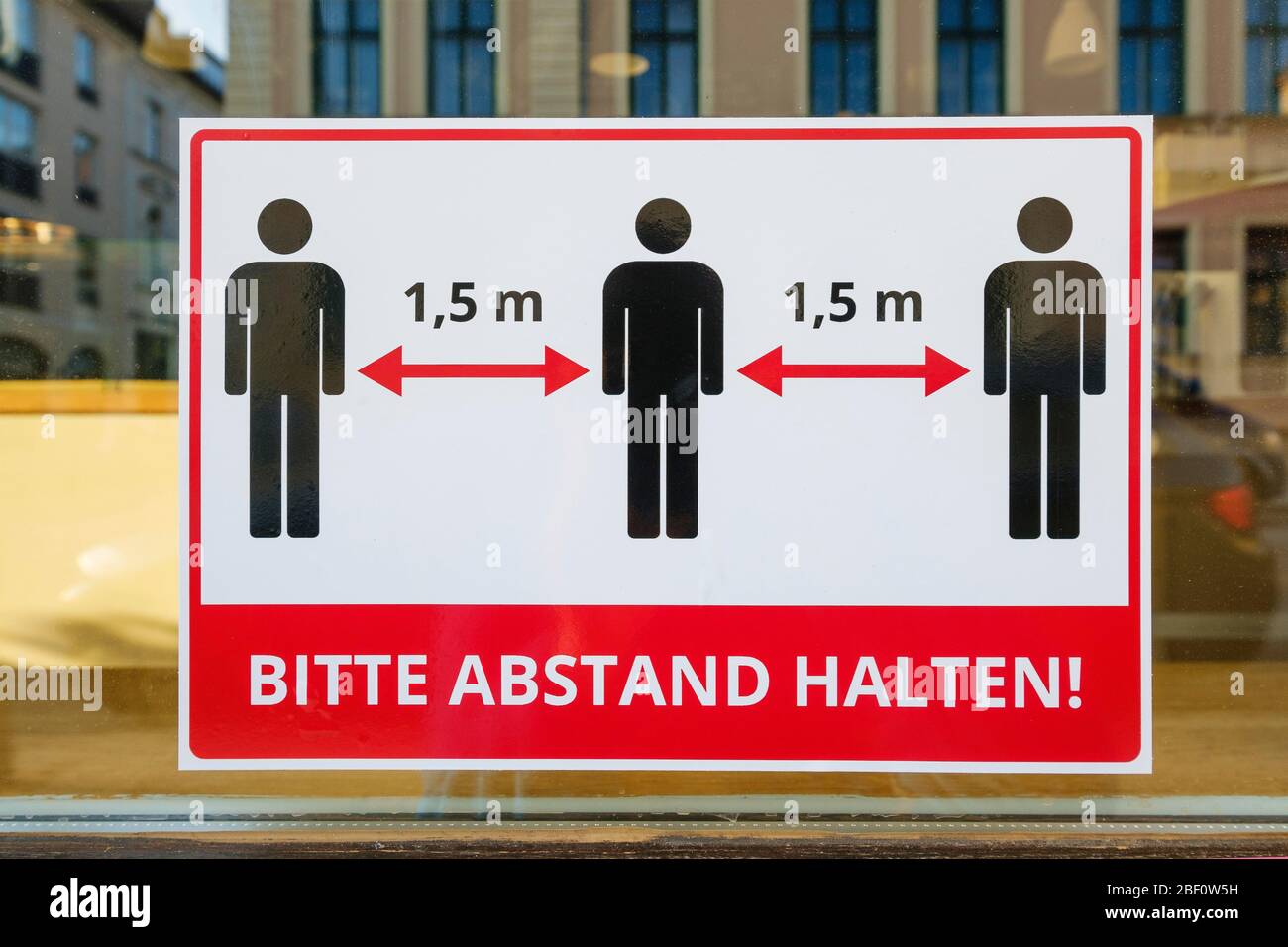 Coronavirus protection sign on shop window, Please keep your distance, Munich, Upper Bavaria, Bavaria, Germany Stock Photo