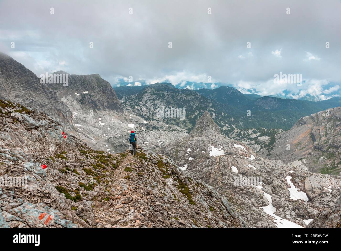 Climber on marked route from Simonyhuette to Adamekhuette, rocky alpine terrain, mountain landscape, Salzkammergut, Upper Austria, Austria Stock Photo