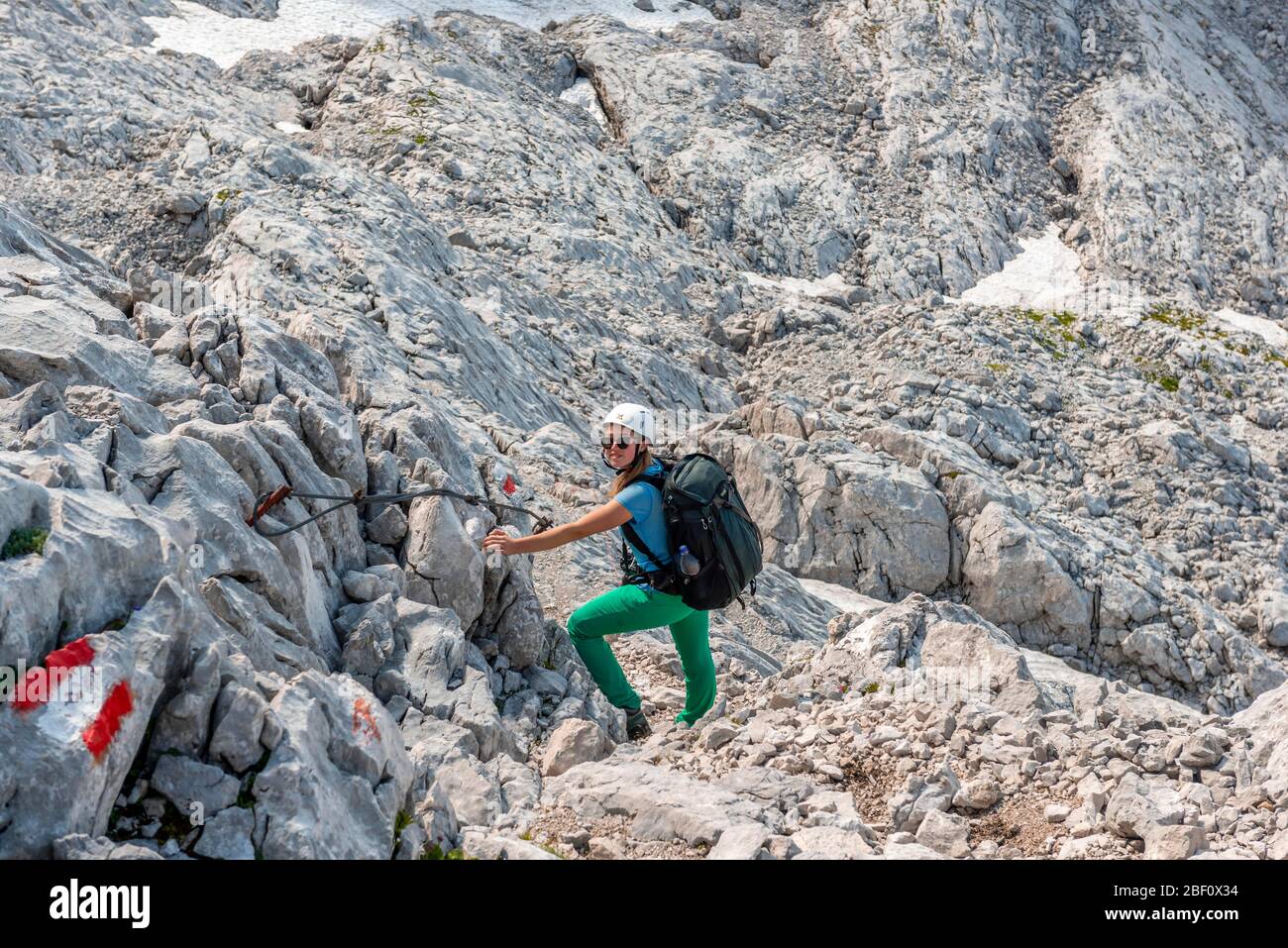 Mountaineer on secured route from Simonyhuette to Adamekhuette, rocky alpine terrain, Salzkammergut, Upper Austria, Austria Stock Photo