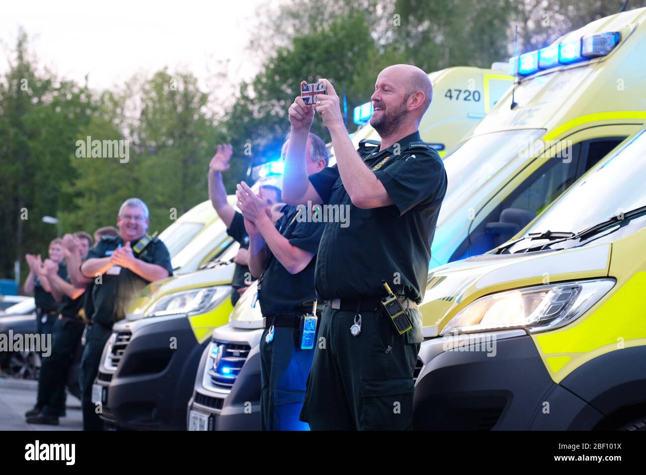 Hereford, Herefordshire, UK – Thursday 16th April 2020 – NHS ambulance crew and paramedics stand outside the A&E unit at the County Hospital in Hereford at 8pm to clap for their colleagues and other key emergency workers for the fourth consecutive Thursday since the Coronavirus Covid-19 lockdown started. Photo Steven May / Alamy Live News Stock Photo