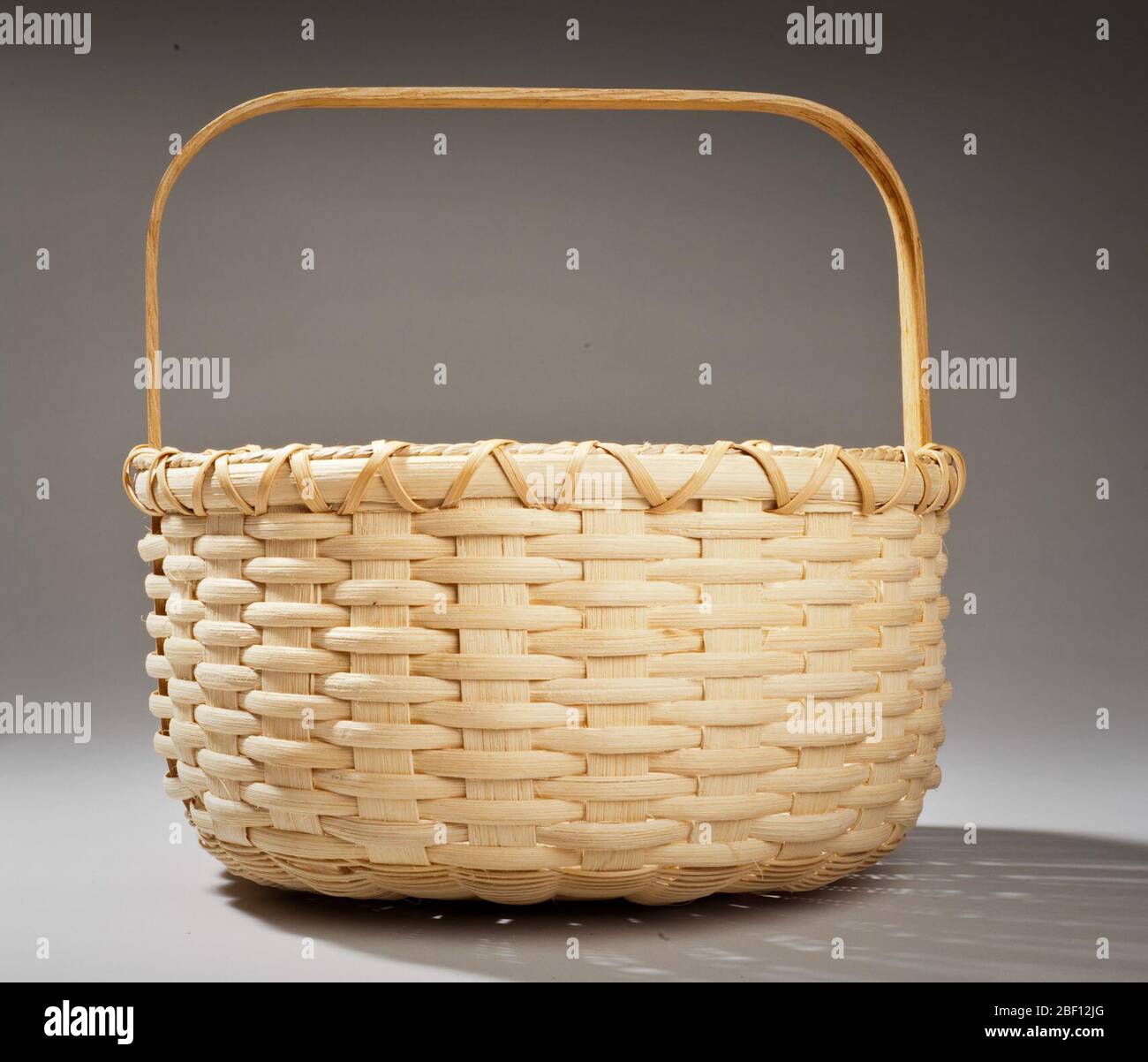 https://c8.alamy.com/comp/2BF12JG/handmade-oval-basket-with-square-handle-2BF12JG.jpg