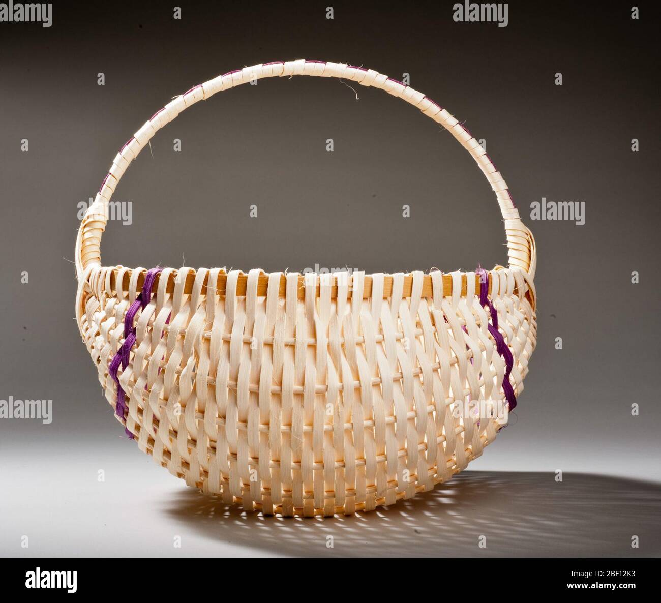 Handmade Reed Basket with Handle and Vertical Stripe Design Stock Photo ...
