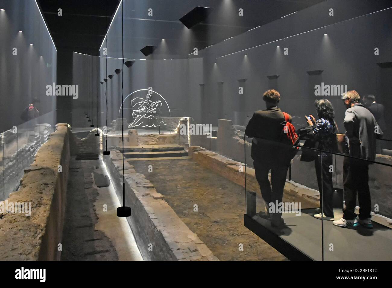 Visitors view London historical Walbrook Roman Mithraeum Mithras temple archaeological site restored by the Bloomberg company  City of London UK Stock Photo
