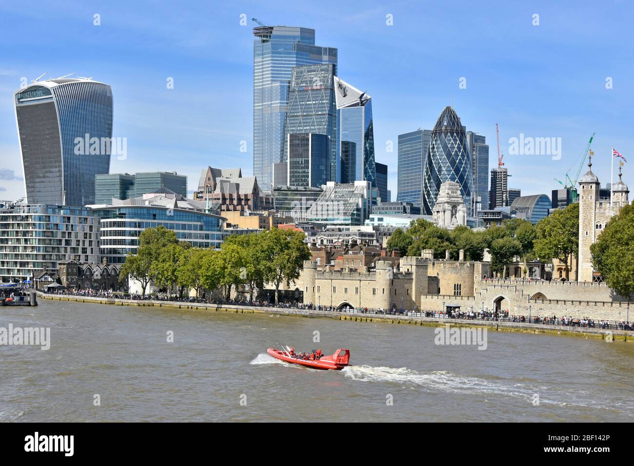 Thames Rockets speedboat business operate fast RIB sightseeing tours on River Thames passing historic Tower of London & modern city skyline England UK Stock Photo