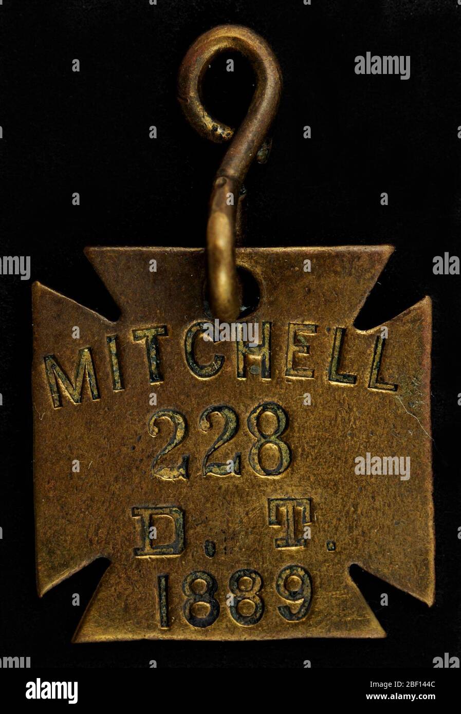 Mitchell Owney tag. Owney received this token while visiting the town of Mitchell, South Dakota. As the tag notes, in 1889, Mitchell was still part of the Dakota Territory (the territory became North and South Dakota late in the year, on November 2, 1889). Stock Photo