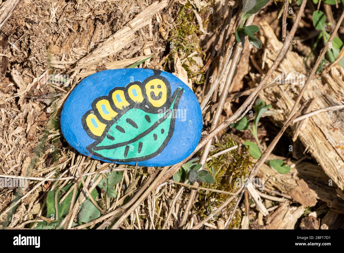 The kindness rocks project, a pebble painted by children with a hungry caterpillar character, UK Stock Photo