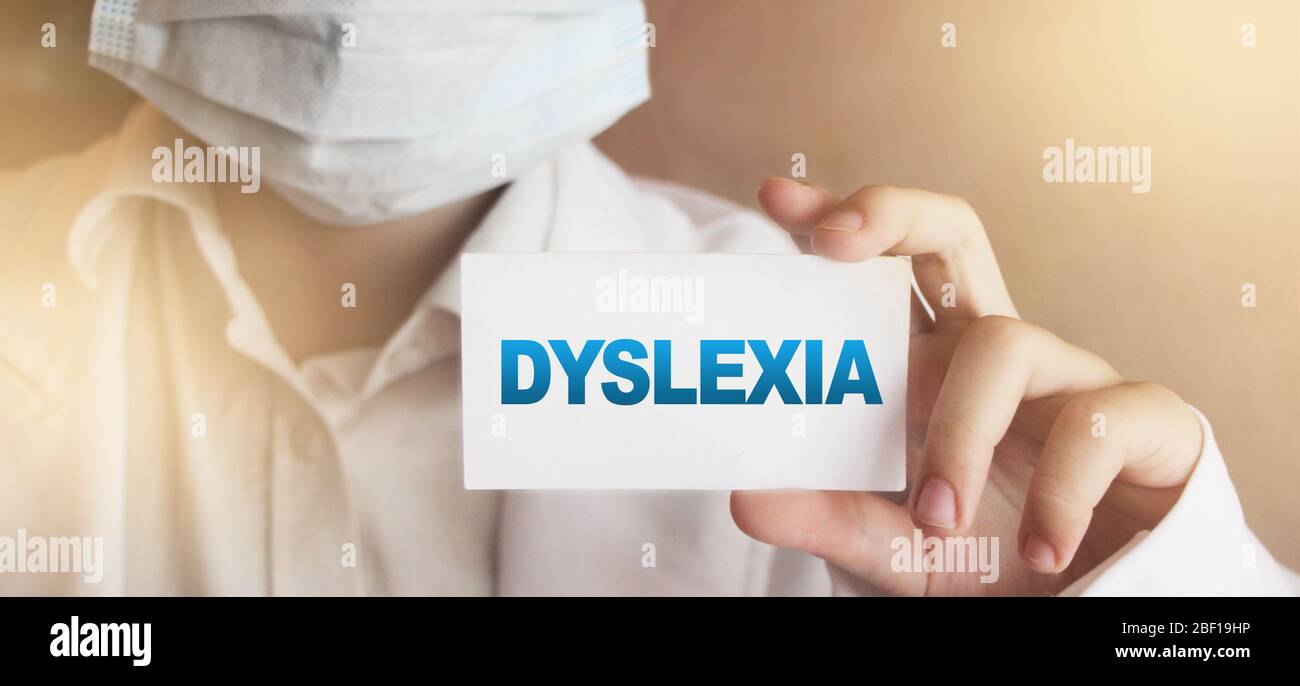 Dyslexia word on card. Doctor keeps a card with the name of the diagnosis dyslexia. Selective focus. Medical concept Stock Photo