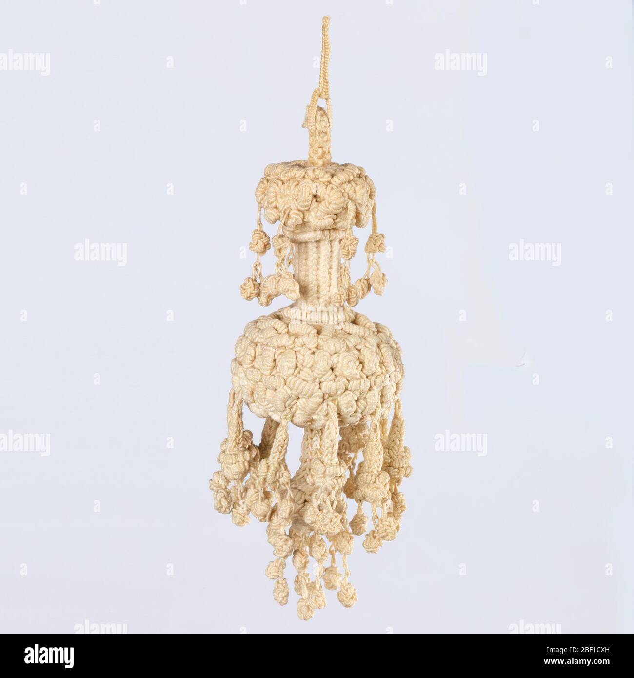Tassel. Knotted white linen tassel with human figures decorated with