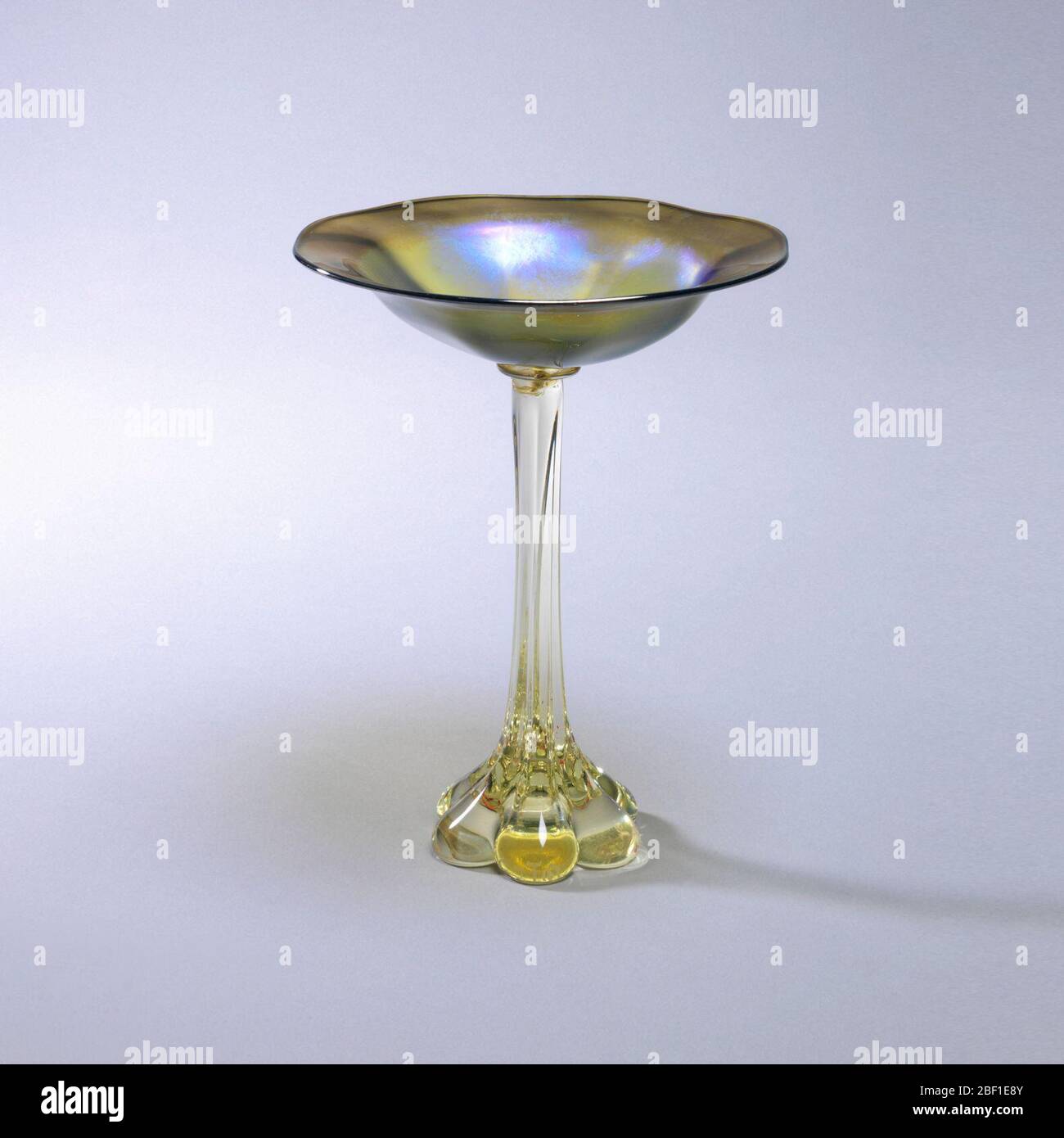 Candy dish. Tall footed candy dish. Slight yellow glass foot, bluegreen dish Stock Photo Alamy
