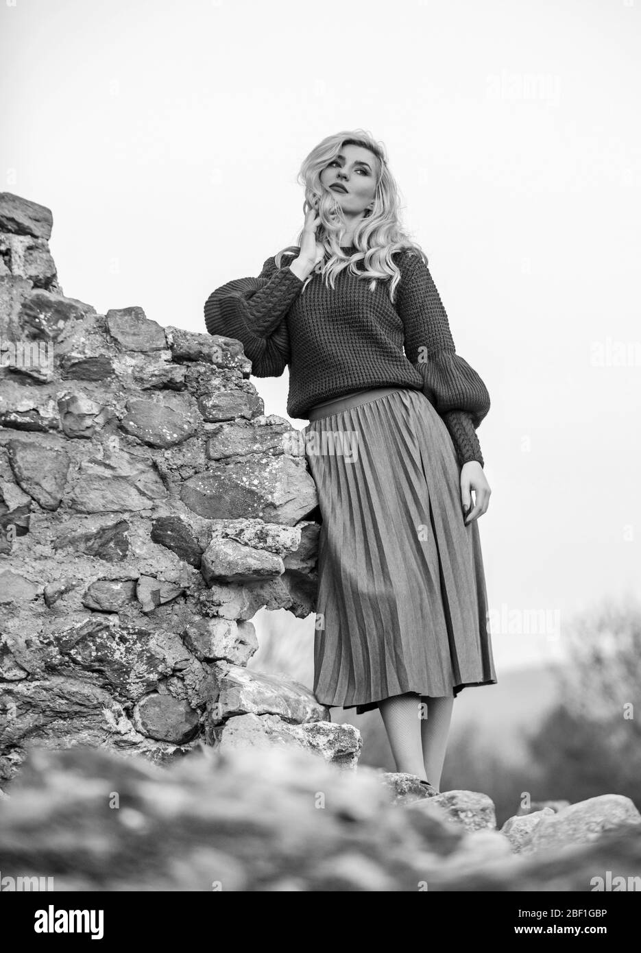 Elegance concept. Trendy clothes. Woman warm sweater nature background defocused. Fancy girl makeup face wear knitted sweater. Messy chic style. Gorgeous lady feeling cozy in woolen sweater. Stock Photo