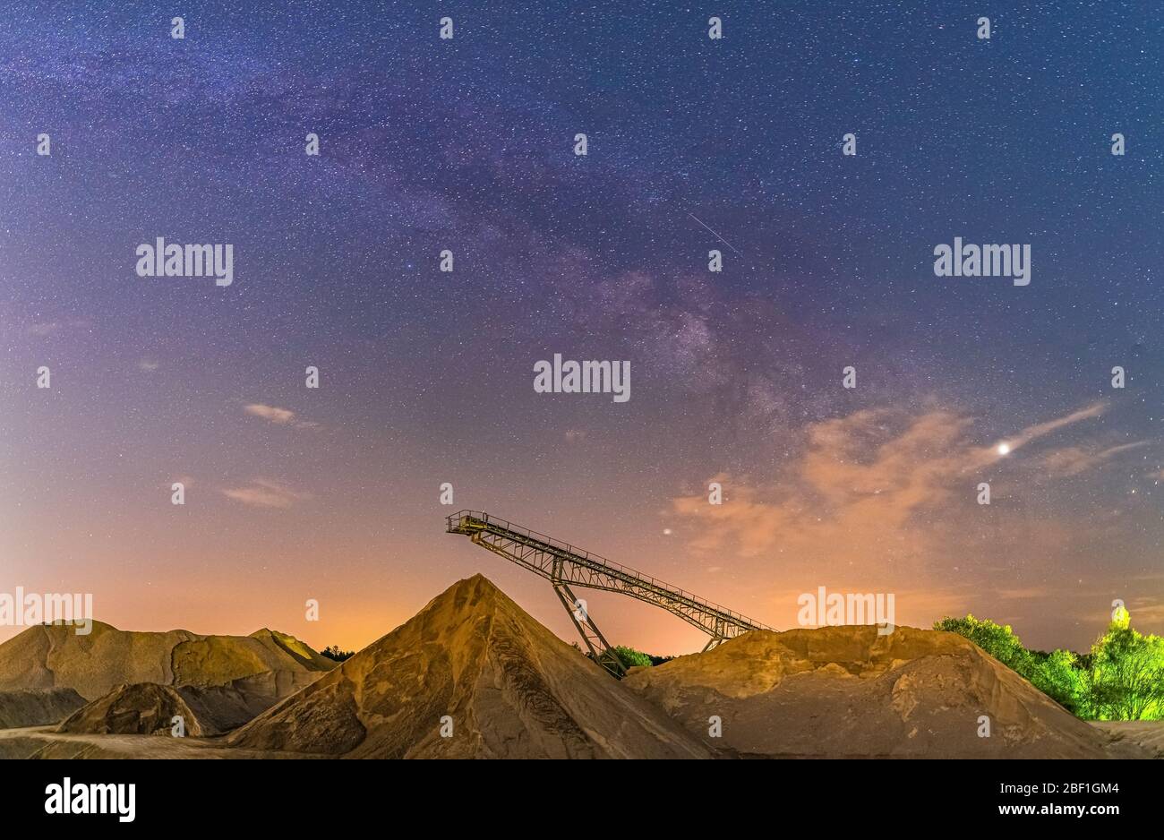 Conveyor bridge at night and milky way, watching the stars at a construction area. Stock Photo