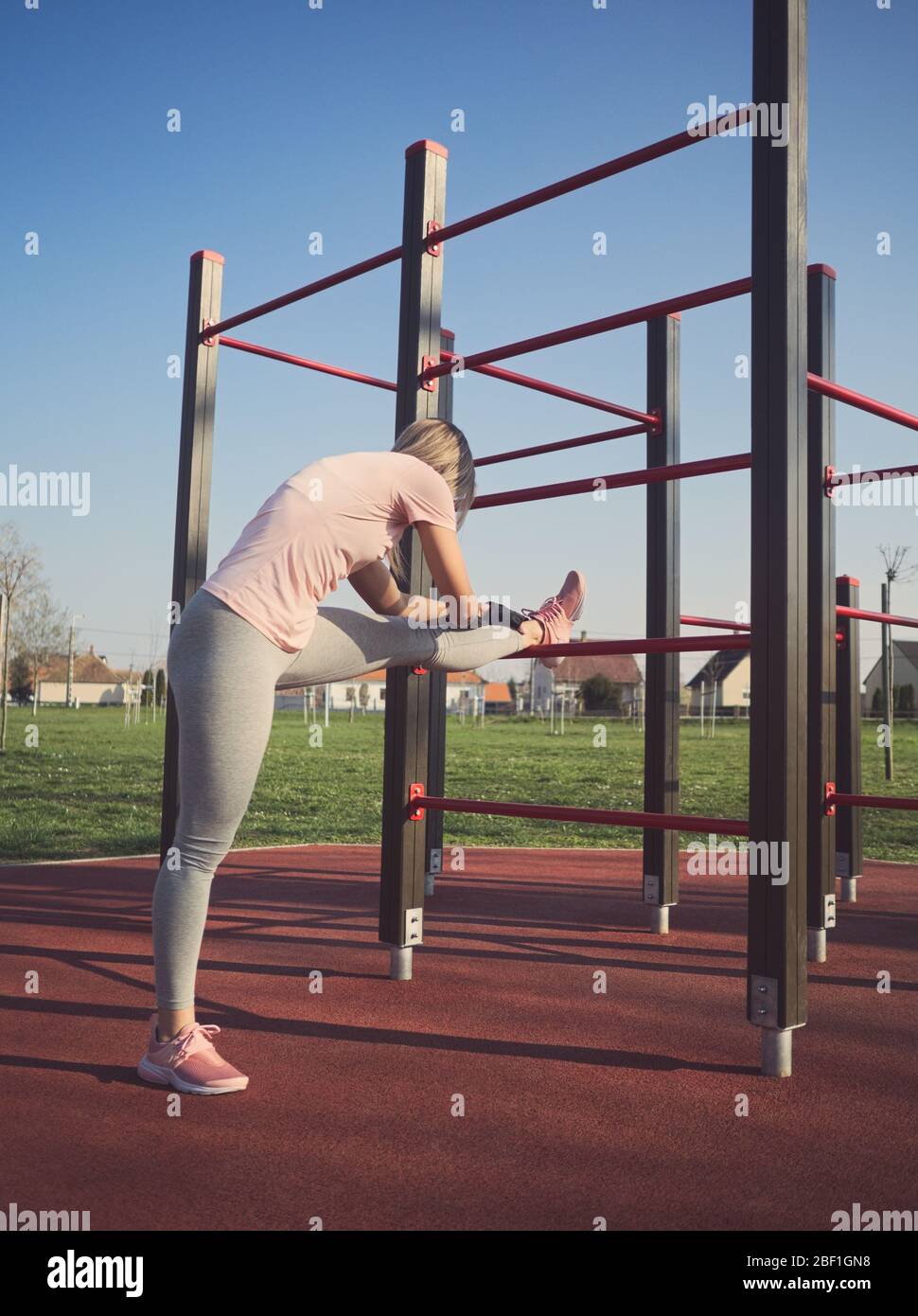 Athletic woman stretching legs hi-res stock photography and images - Alamy