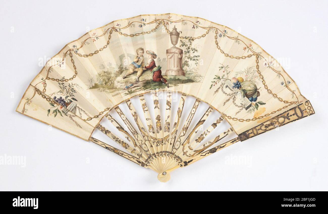 Pleated fan. Pleated fan. Parchment leaf gilded and painted in gouache showing two boys in a landscape next to a tomb. A painted chain casts a trompe-l’oeil shadow on border. Pierced and carved ivory sticks, gilded and silvered. Rivet is set with a faceted stone Stock Photo