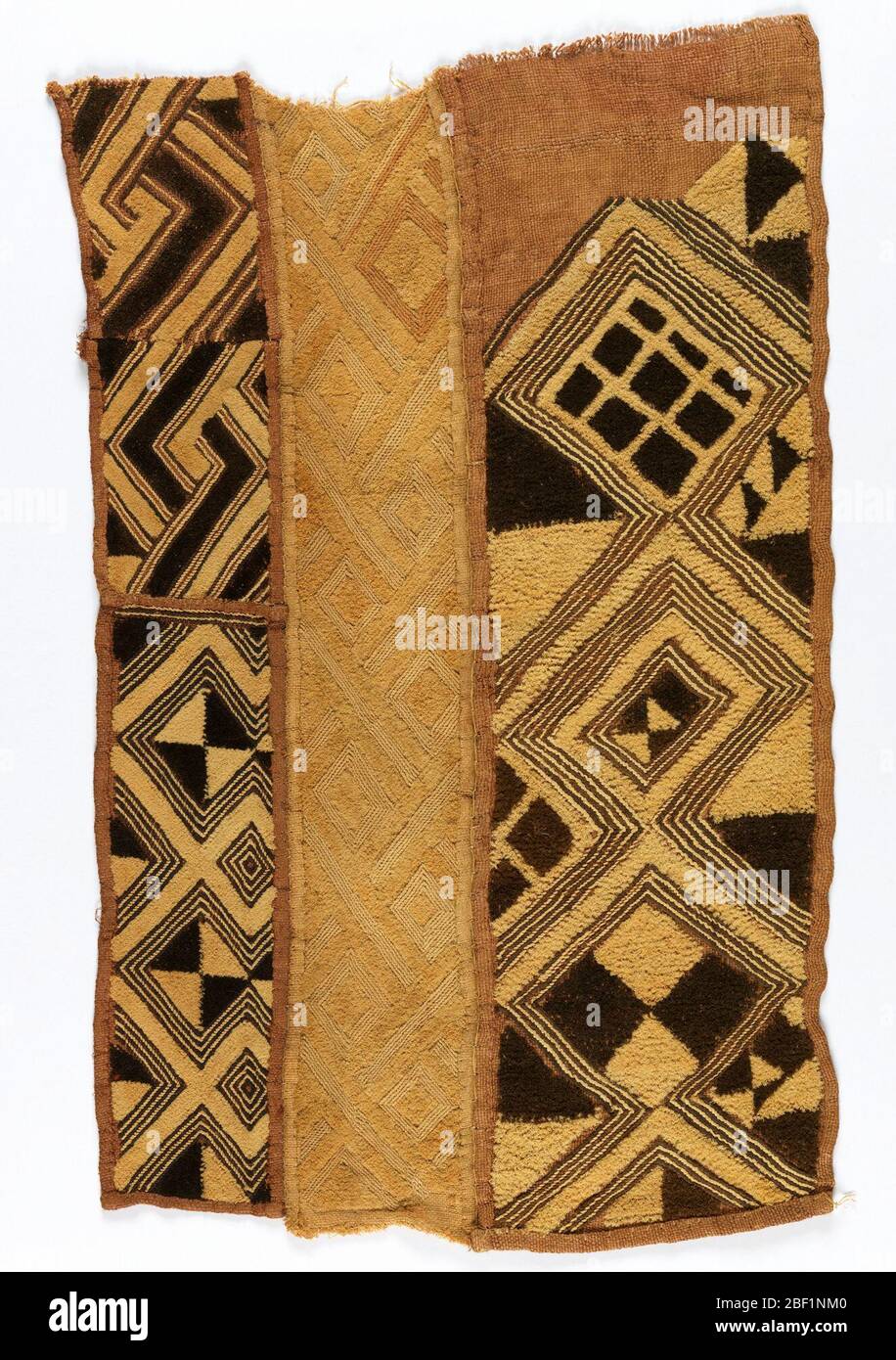 Status cloth. Four pieces of woven raffia seamed together down the long sides with buttonhole stitch to form a rectangular panel. Each piece is patterned with irregular geometric forms in tan and dark brown raffia pile with reddish-brown outlining stitch. Stock Photo