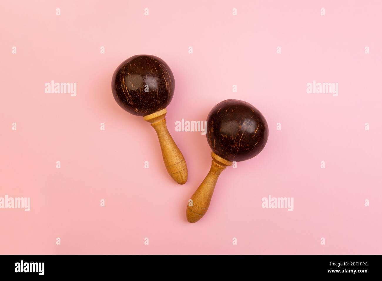Two mexican maracas isolated on pink background. Traditional folk musical instruments. Elements of national culture. Flat lay. Latin music. Stock Photo