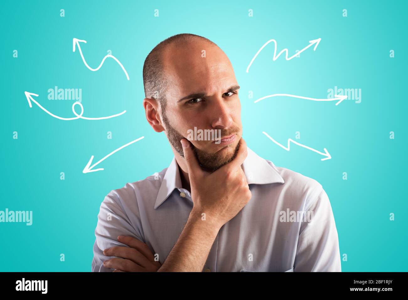 Confused and pensive man thinks about the best way forward Stock Photo