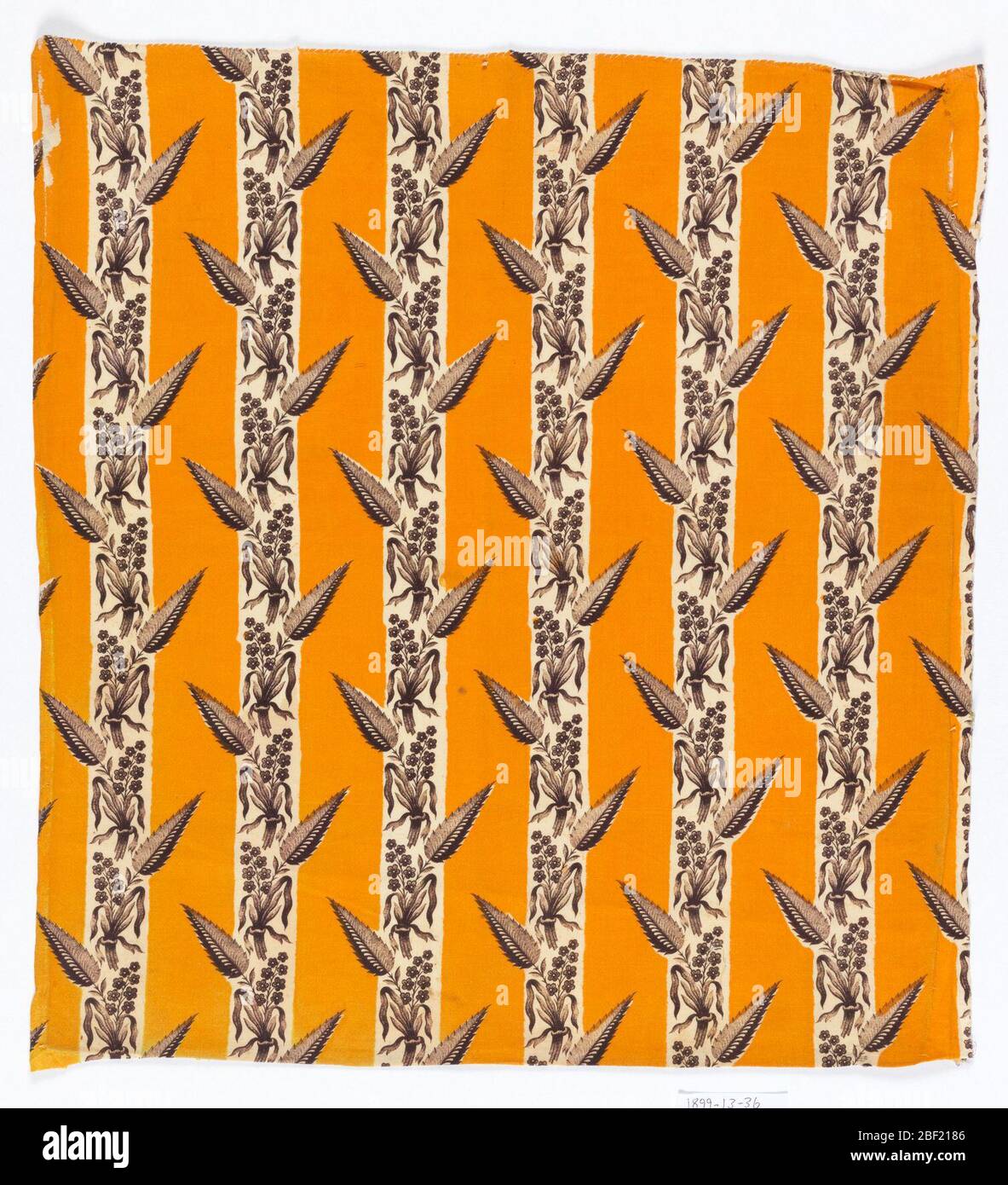 Textile. Alternate stripes of chrome orange (solid) and brown floral sprays with saw-toothed leaf. Stock Photo
