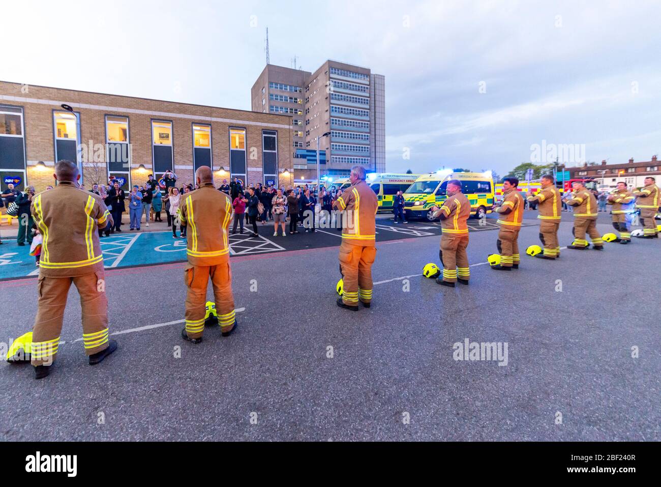 Firefighters clapping at Clap for Carers at 8pm outside Southend Hospital in evening to thank NHS and key workers during the COVID-19 Coronavirus Stock Photo